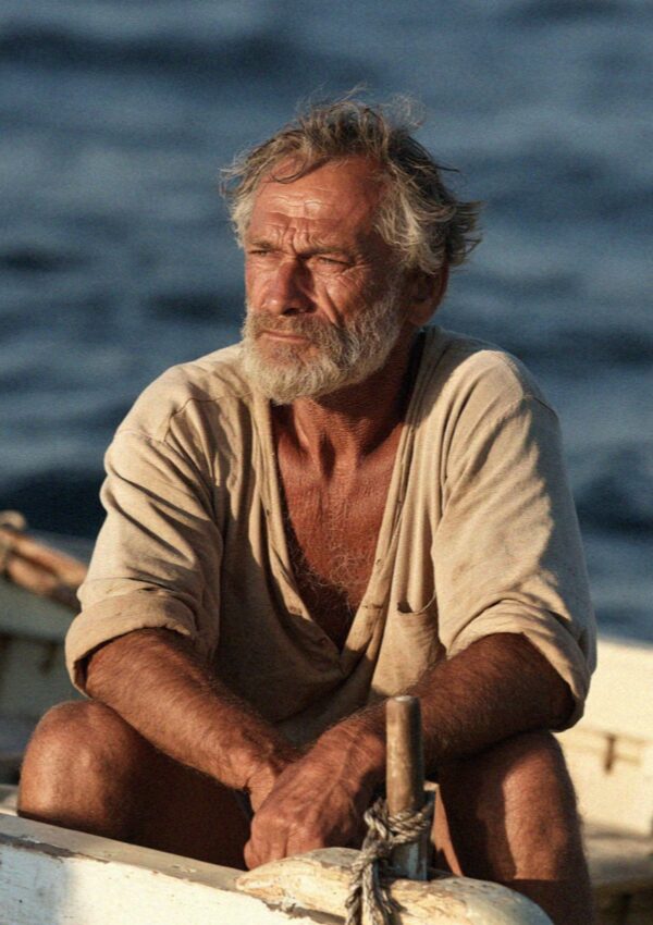 The boatman at the tiller of a small open boat off Filicudi in the Aeolian Islands