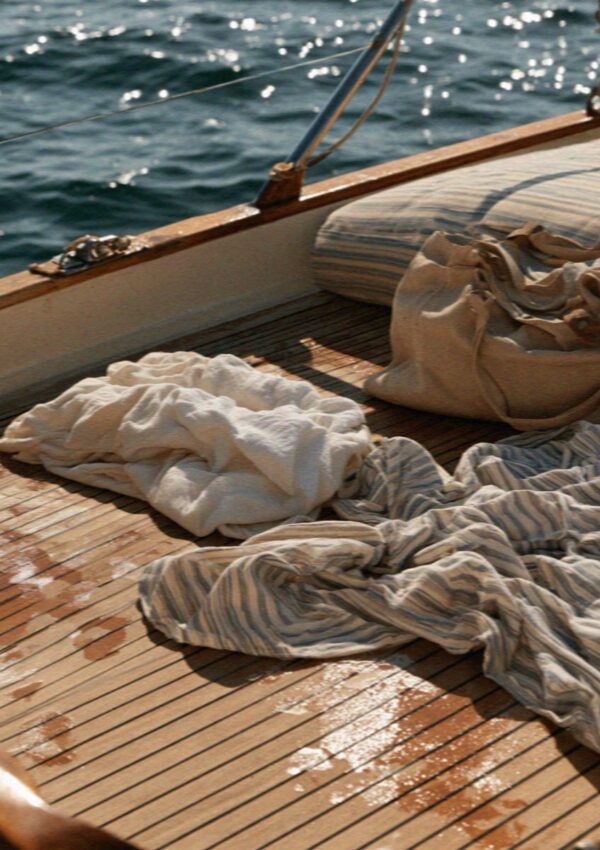 Bags and towels left on a wooden boat deck north of the Costa Smeralda in Sardinia