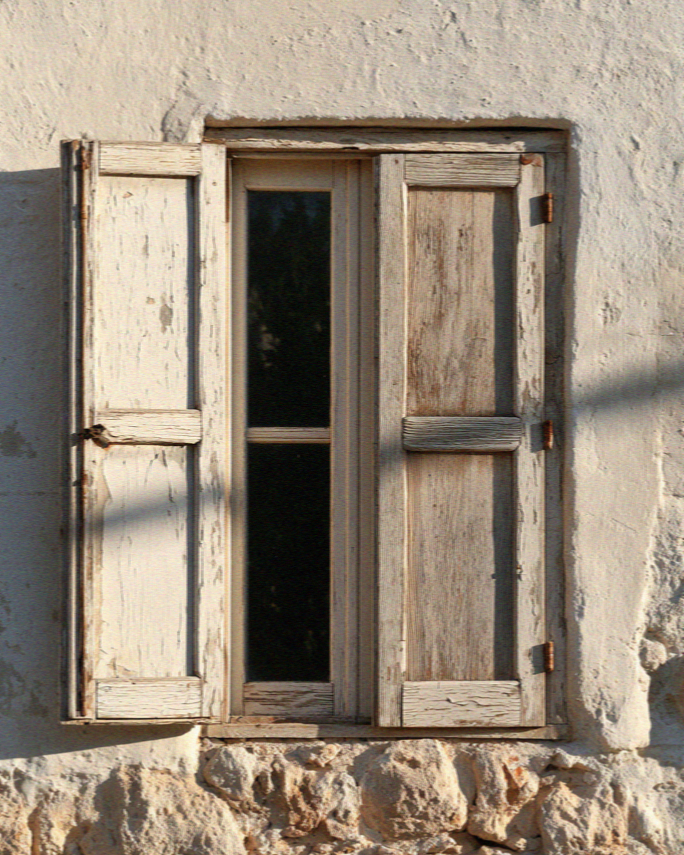 A sun-blistered shutter closed against the afternoon heat in Matera