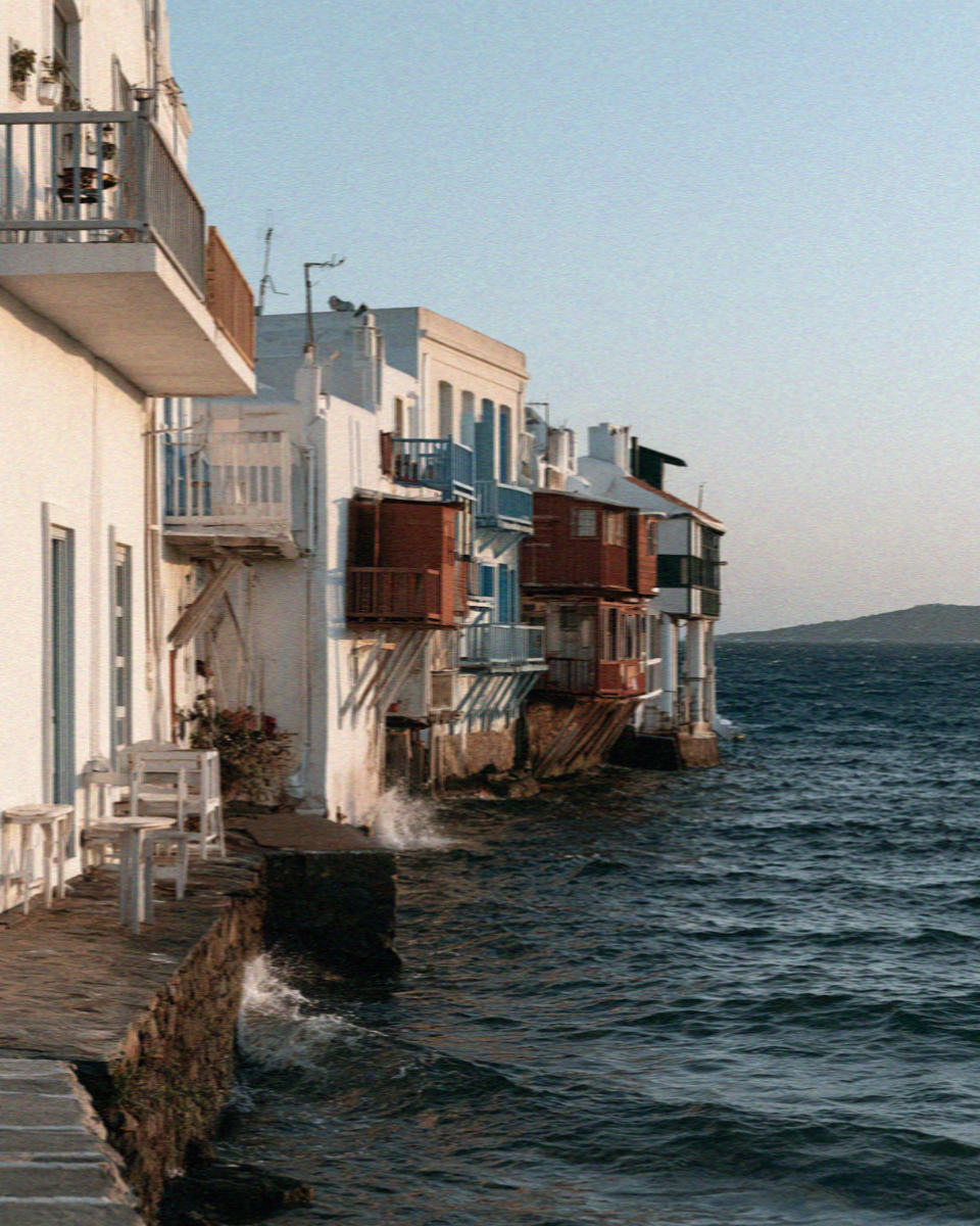 Waterfront houses with wooden balconies hanging directly over the sea at Little Venice in Mykonos