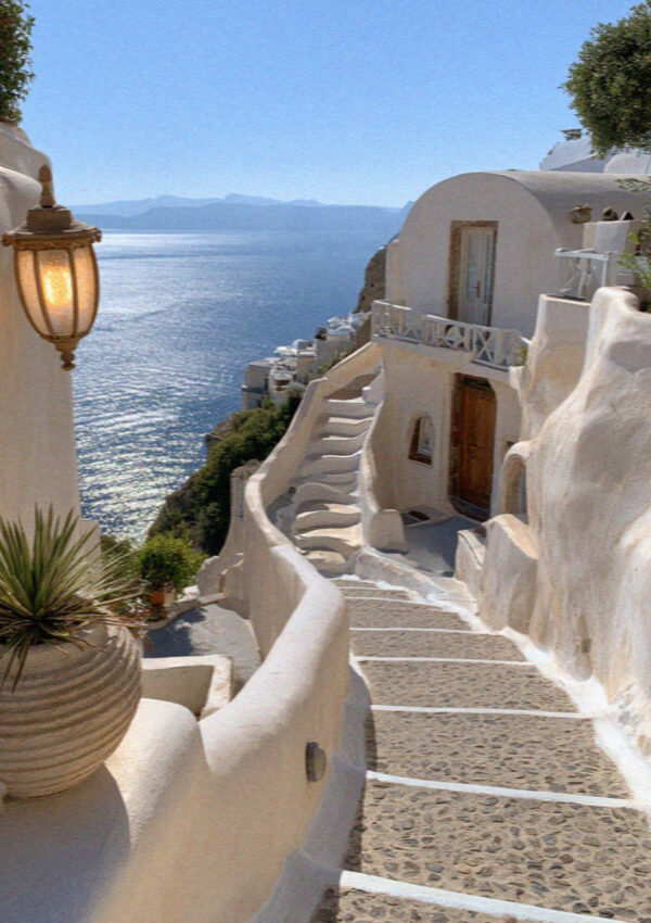 Lamplit steps running down toward the water in Santorini