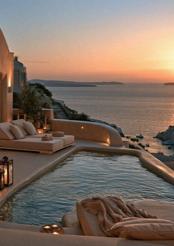 A pool terrace above the caldera in Santorini at dusk