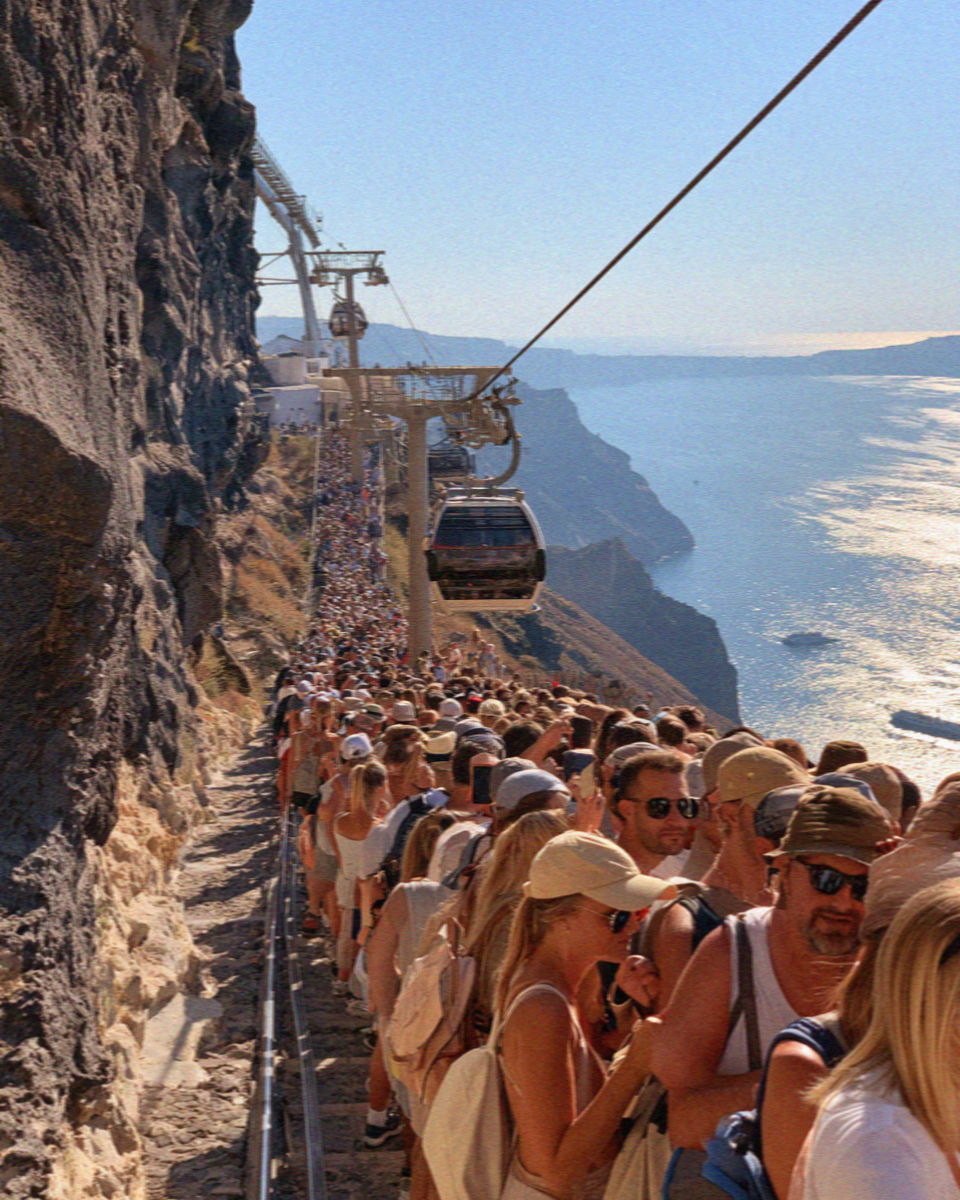 The queue winding down the cliff steps to the old port in Santorini