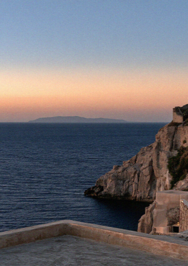 The water below the cliffs in Santorini after the sun has gone