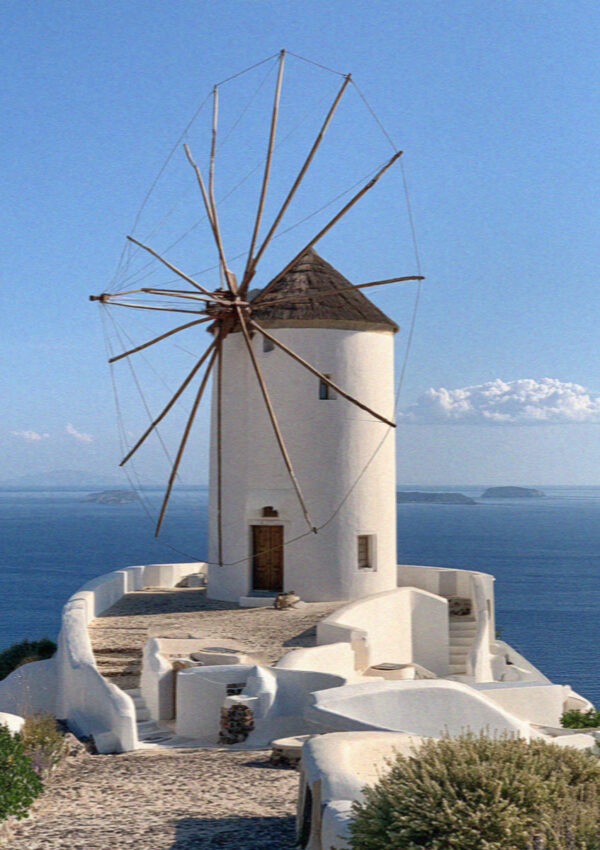 A whitewashed windmill above the sea in Santorini
