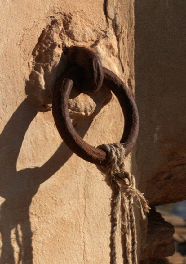 A rusted iron mooring ring set into the wall at the tonnara at Scopello, west of Palermo in Sicily