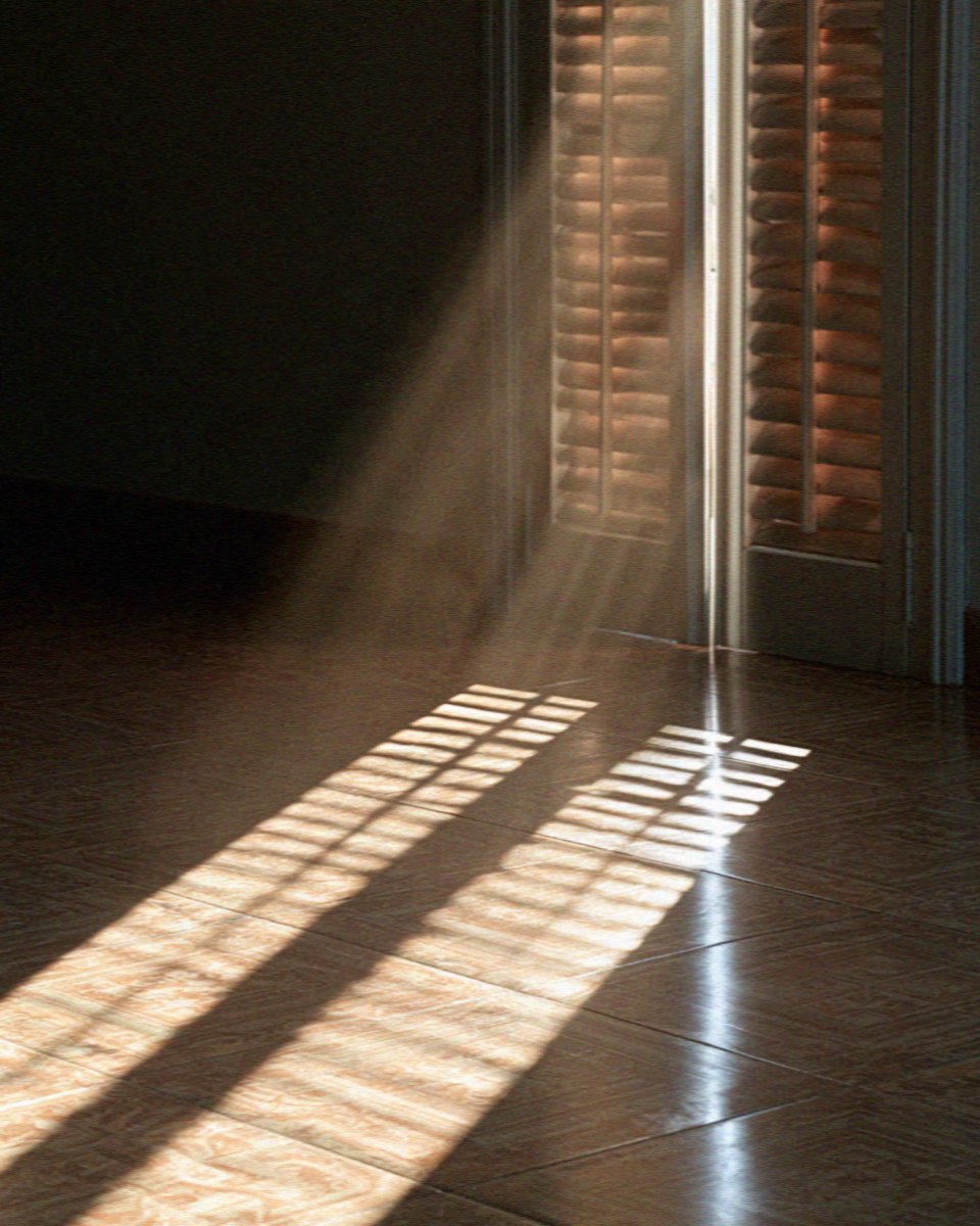 Light through shutter slats falling across tiles in a room at Scopello, west of Palermo in Sicily