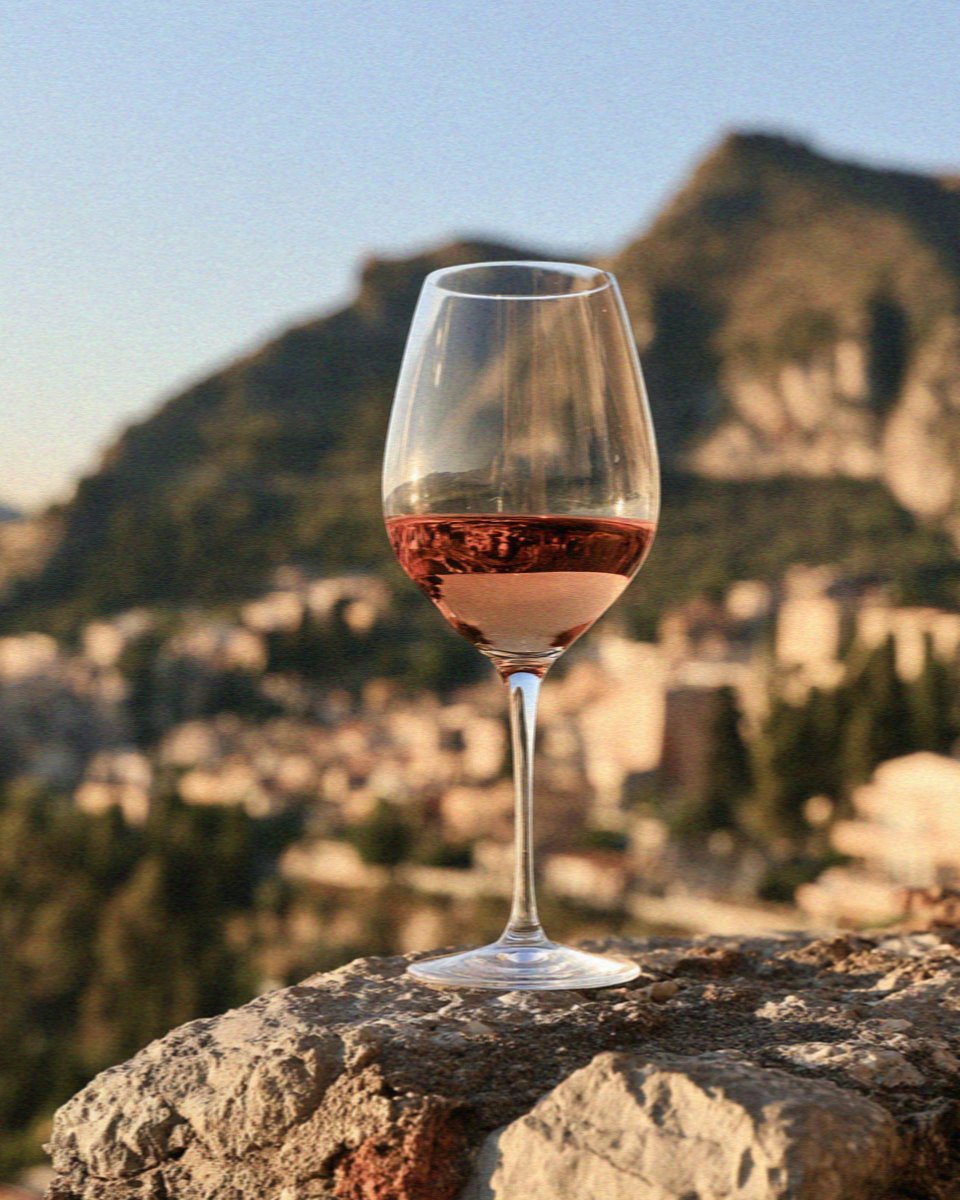 A glass of Etna wine on a stone ledge in Taormina in Sicily