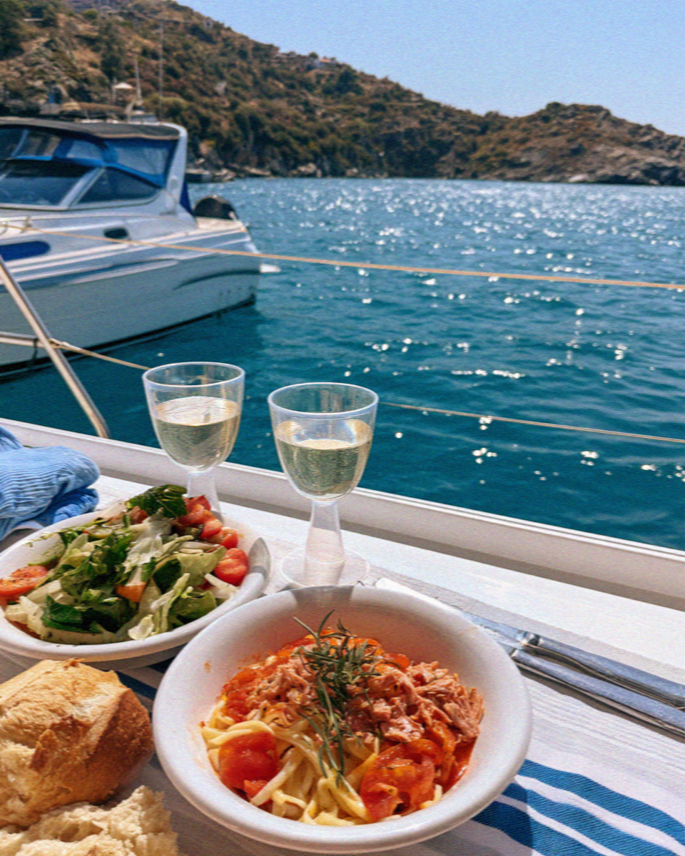 Greek salad and white wine served on deck off Milos
