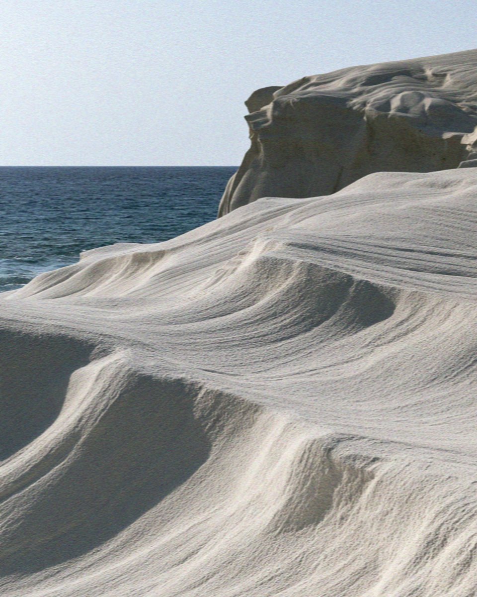 The wind-carved white rock of Sarakiniko on Milos in the soft light at dusk