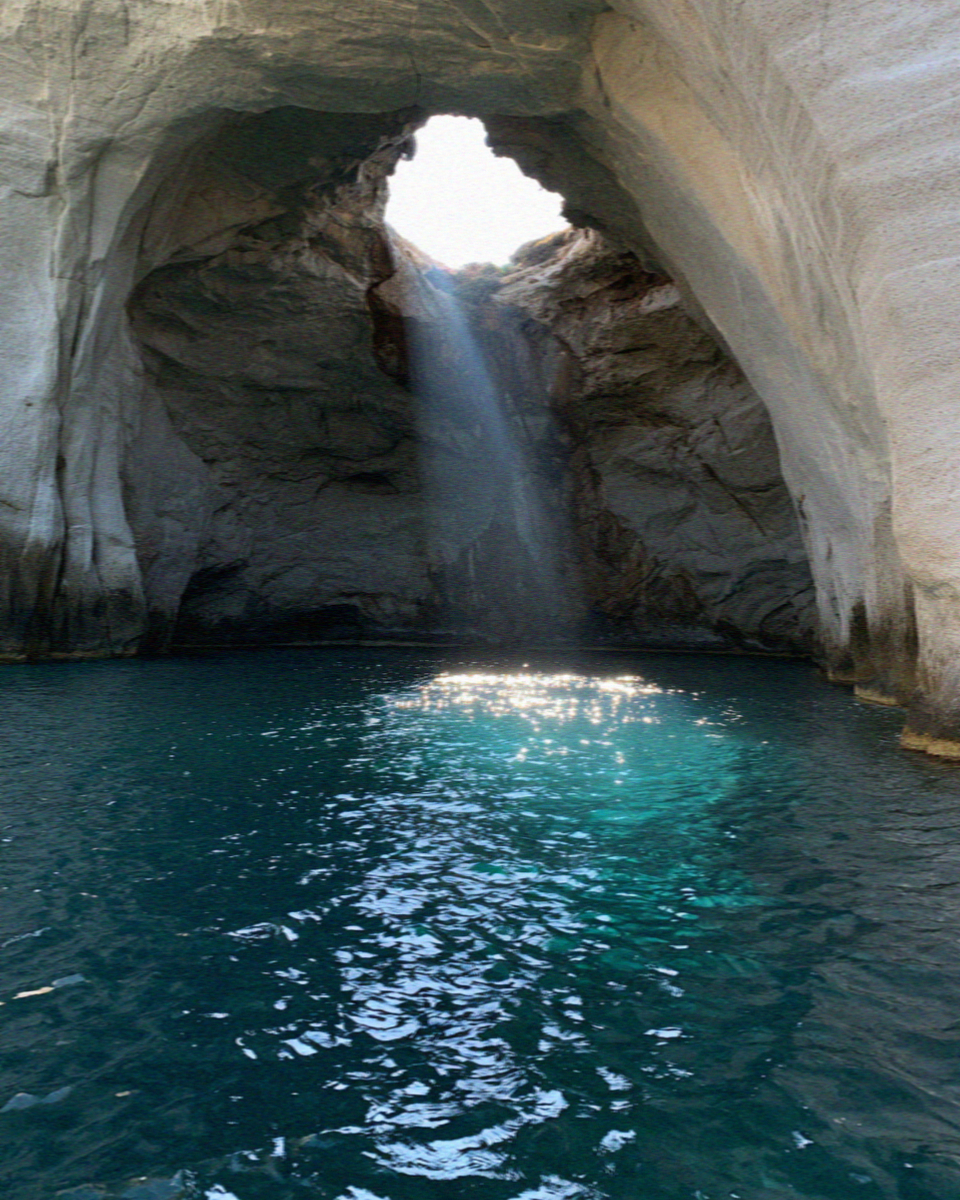 The Sykia sea cave on Milos with light falling through the collapsed roof