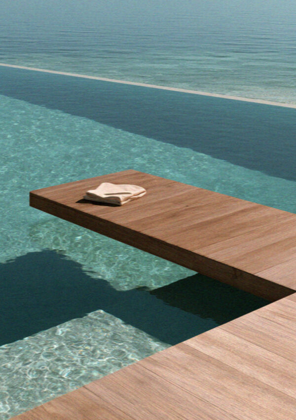Breakfast laid out on a wooden deck beside a villa infinity pool on Mykonos
