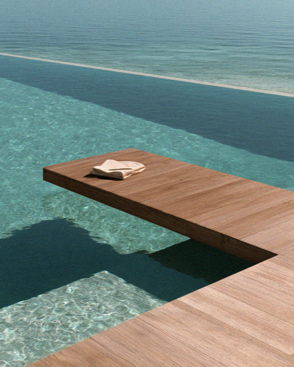 Breakfast laid out on a wooden deck beside a villa infinity pool on Mykonos