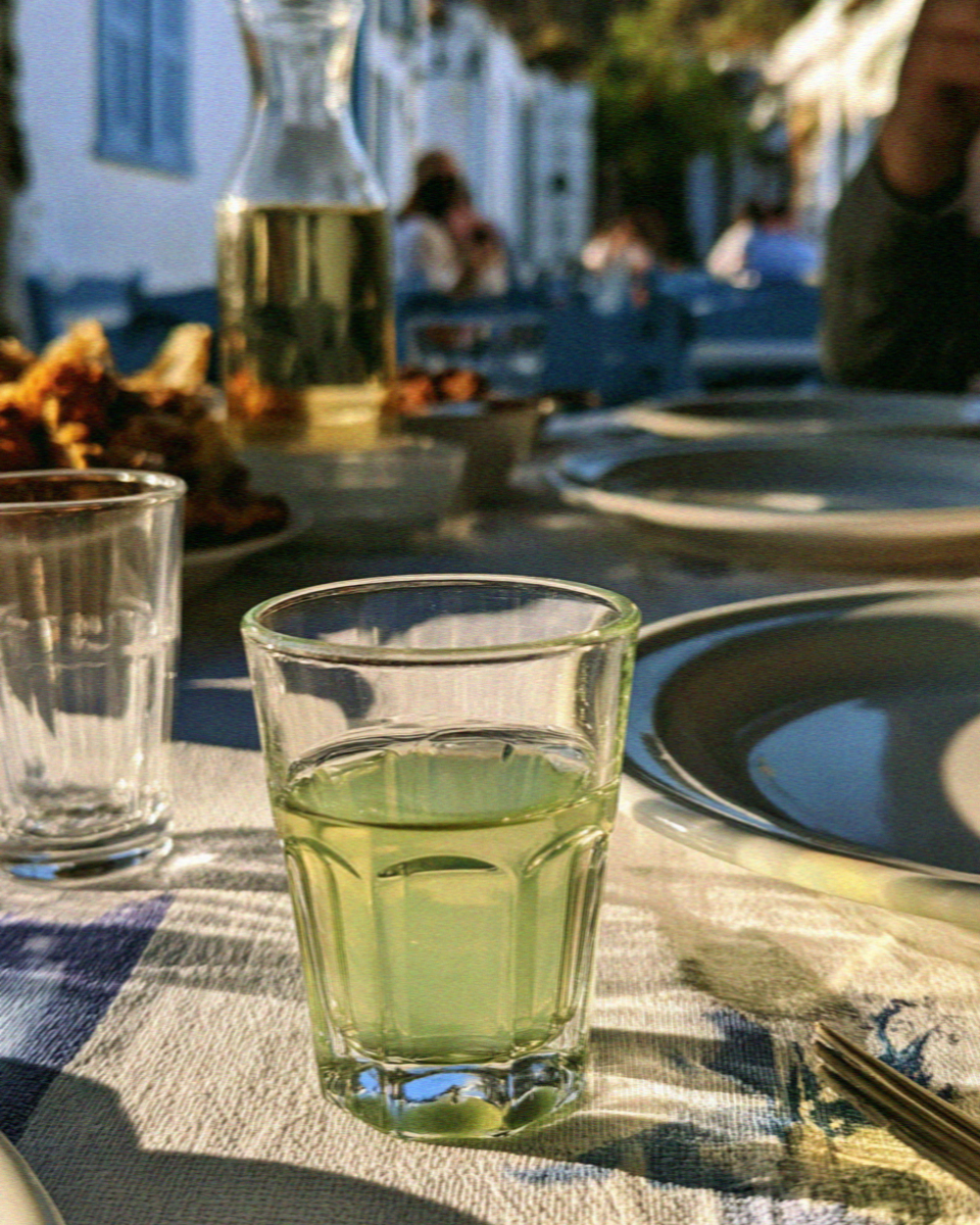 A glass of green kitron, the Naxian citron liqueur, on a taverna table in Naxos