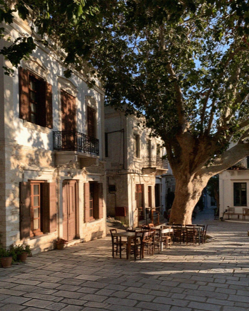 Neoclassical house fronts and a plane tree on the square of Halki village on Naxos