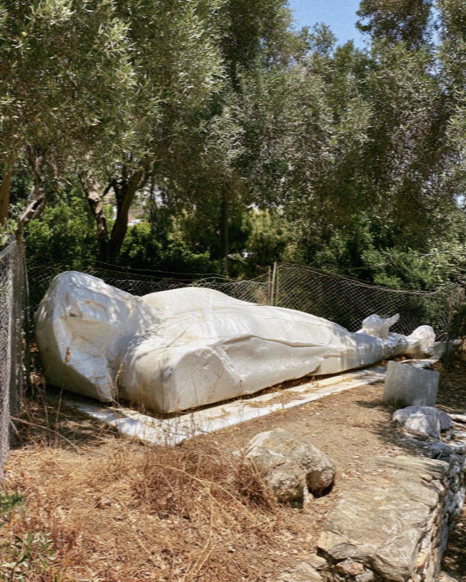 The unfinished marble kouros lying on his back in an olive garden at Flerio on Naxos