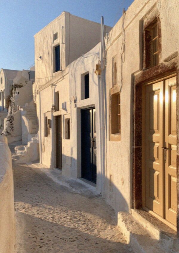Whitewashed lanes and doorways of Pyrgos on Santorini in warm late afternoon light